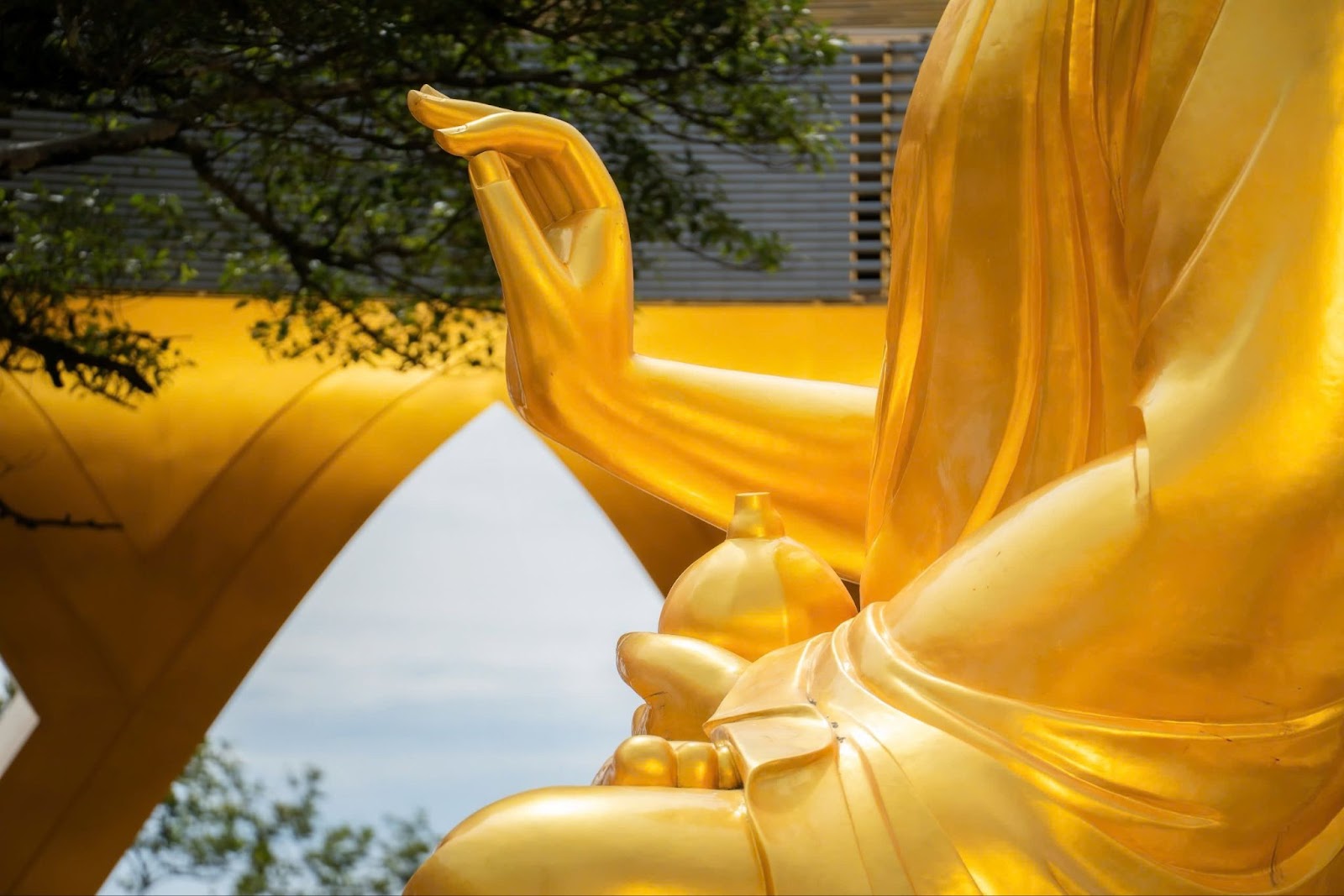 Hình ảnh tay trái nâng quả sung, tay phải bắt ấn giáo hoá của tượng Phật Câu Na Hàm 